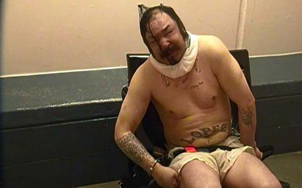 Christopher Lopez, 35, sits restrained with a spit hood over his head in the final hours of his life. (Provided by the Colorado Department of Corrections via a lawsuit by the estate of Christopher Lopez)