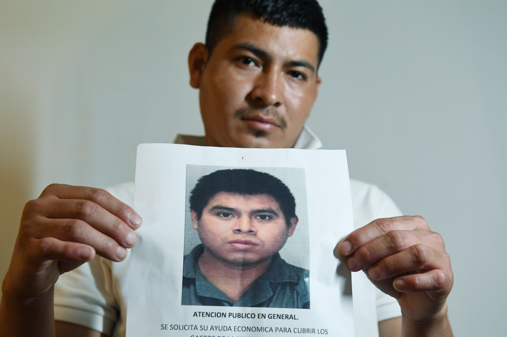 Noe Sanchez Amaya, 27, an uncle of Giovanny Martinez, holds a flier Fairfax County police circulated as they tried to identify Martinez after he was fatally shot. (Matt McClain/The Washington Post)