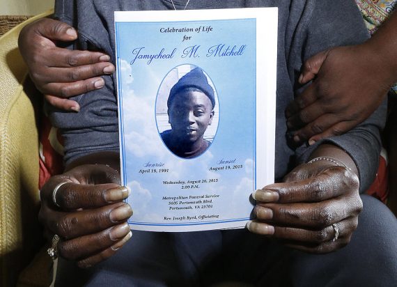 Sonia Adams holds the program for her son Jamycheal Mitchell's funeral as her sister Roxanne Adams stands behind her Friday, May 6, 2016. Mitchell was found dead in his cell at Hampton Roads Regional Jail.