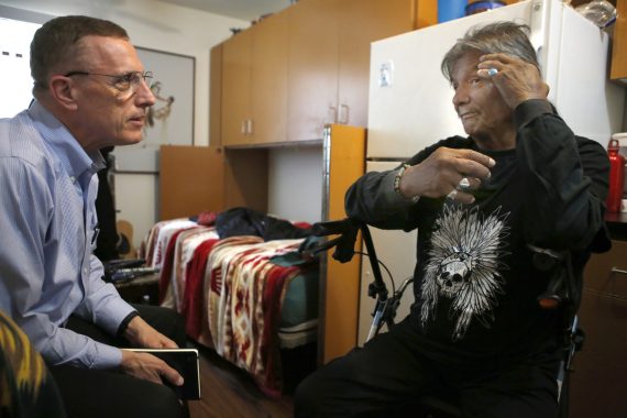 Rep. Timothy F. Murphy (R-Pa.), left, speaks with Richard LaRush in LaRush's Step Up on Second apartment. (Christian K. Lee / Los Angeles Times) 